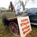 Duane Kempf and Steve Trinkle restock straw and hay for sale on a wagon in front of Jenny's Farm Market, located at the corner of Island Lake Road and Dexter-Pinckney Road just outside Dexter on Wednesday. Melanie Maxwell I AnnArbor.com